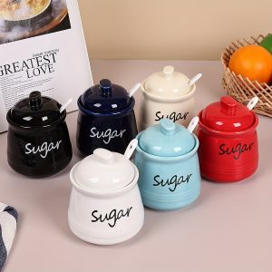 A Single Ceramic Sugar Jar with a Lid And a Small Ceramic Spoon, Suitable for Use As a Sugar Bowl for Cube Sugar, Granulated Sugar, Or As a Kitchen Sugar Dispenser. It Can Also Serve As a Sugar Bowl for Restaurants Or Coffee Bars